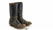 Well-worn cowboy boots on white background, concept of rugged outdoor lifestyle