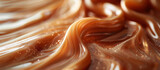 Fototapeta Tulipany - Melted smooth liquid caramel texture abstract background. Sweet food.