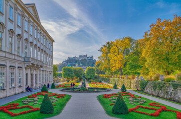 Wall Mural - Salzburg, Austria -  October 6, 2022: The garden of the Mirabell palace with the old town and the Hohenslzburg fortress in the background