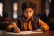 © venusvi - Indian boy studying in school An attentive atmosphere, children learn with interest on a colored background.