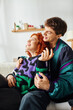 © LIGHTFIELD STUDIOS - beautiful cheerful couple in fashionable cozy clothes hugging each other while at home near bed