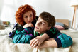 beautiful cheerful woman lying in bed with her handsome young boyfriend with headphones at home