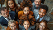 © aekkorn - Top view high angle shot from above group portrait of businesspeople standing together, looking up at camera and smiling.