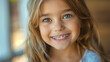 
Portrait of a happy smile of a little girl with healthy white teeth with metal braces. Pediatric dentistry concept