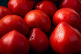 Fototapeta Konie - Fresh ripe red tomato with water drops on a dark background. Close-up.