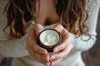 A woman holds a jar of moisturizing cream, emphasizing its role in facial and skincare routines for enhancing beauty and promoting wellness and radiance.