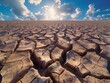 A barren, dry desert landscape with a sun shining brightly in the sky. The sun is the main focus of the image, illuminating the cracked and dry ground. The desolate scene conveys a sense of emptiness