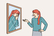 © Dzianis Vasilyeu - Woman scolds own reflection in mirror, for concept of low self-esteem and problems with having self-confidence. Split personality and lack of self-esteem causes disorder or nervous breakdowns