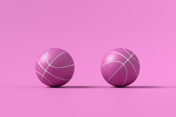 Wall Mural - Two pink basketball balls on pink background.