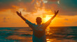 Happy man raising arms up enjoying sunset on the beach - Delightful traveler standing with hands up looking morning sunrise - Self care, traveling, wellness and healthy life style concept