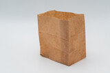 Fototapeta Kosmos - Brown paper bag on white background