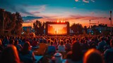 Fototapeta Uliczki - A large crowd of people are watching a movie on a big screen. The sky is orange and the atmosphere is lively