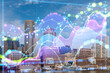 Boston skyline with a digital holographic overlay of financial charts, representing business and technology concept with a cityscape background. Double exposure