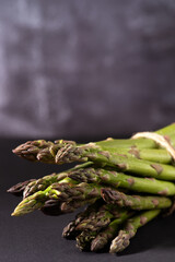 Fresh green asparagus on dark background