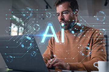 Thoughtful businessman programmer in casual wear typing on laptop at office workplace. Concept of tech work, business education, internet surfing, information technology. Ai hologram