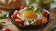 Fried egg in skillet with tomatoes and basil