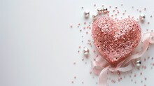 Frosted Pink Glitter Heart With Pink Ribbon And Beads On White Background
