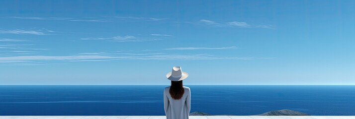 Wall Mural - A woman is sitting on the edge facing the sea. The view is peaceful and serene, with vast expanses of water stretching out in the distance