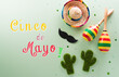 Cinco de Mayo holiday background made from maracas, mexican blanket stripes or poncho serape, cactus and hat on pastel background.