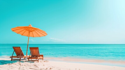  Tranquil beach scene with sun loungers and orange umbrella on white sand