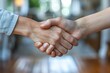 © Larisa AI - Close-up shot of a firm handshake between two people, symbolizing trust and agreement in a professional setting