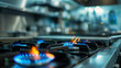 A professional bright kitchen with a blurred background - gas oven - orange tongues of blue flame of a gas burner