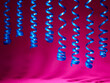 decorative blue streamer ribbon on pink background