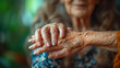 Elderly Care of a Young Woman Holding the Hand of a Senior Blurred Background
