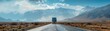 Lone semi truck dominates the mountainous highway under the vast open sky transporting cargo through the rugged and dramatic landscape