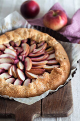 Wall Mural - Galette with apples and elder berries on wooden board.