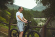 © Taras Grebinets - Portrait of a Caucasian young athletic man using electric bike, bicycle, riding in mountains