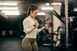 © dusanpetkovic1 - Side view of a fit strong sportswoman practicing on a cable machine in a gym.
