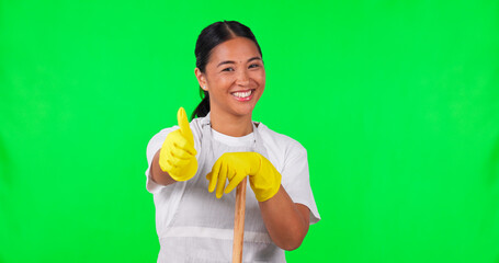 Canvas Print - Happy asian woman, housekeeper and thumbs up on green screen for clean hygiene against a studio background. Portrait of female person, maid or cleaner with like emoji, broom or yes sign on mockup