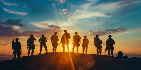 A group of soldiers stand on a hillside, looking out over the horizon. The sun is setting, casting a warm glow over the scene. The soldiers are all wearing camouflage uniforms