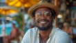 © marimalina - Smiling man wearing straw hat and sunglasses enjoys sunny day at beachside cafe with colorful umbrellas in the background
