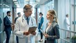 © PhotoPhreak - Pharmaceutical Sales Representative Consulting with Female Doctor in Hospital: Healthcare Staff Discussion