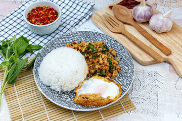 Wall Mural - Traditional Thai street food, stir-fried minced chicken with basil, chili, and garlic, served with a fried egg