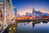 Fototapeta Paryż - Nashville, Tennessee, USA. Cityscape image of Nashville, Tennessee, USA downtown skyline with reflection of the city the Cumberland River at spring sunset.