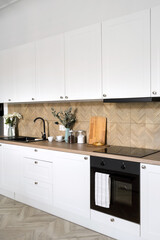Wall Mural - White cupboard, induction stove and electric oven in modern kitchen