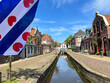 Frisian flag at a canal during summer in Dokkum