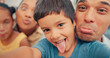 © peopleimages.com - Family, selfie and funny face of children and parents together in a living room at home. face of a man, woman and young kids together for fun, happiness and picture while playing for bonding and care