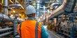 © Your isolated stock - Back View of Man in Protective Vest Visiting Factory: Industrial Safety Inspection