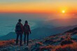 Two hikers admire the sunrise over mountainous terrain, vibrant sky.