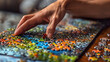 Hands of Senior Woman Doing Puzzle. Close up of Wrinkled Elderly Female Hands Putting Pieces of Yellow Jigsaw Puzzle Together. Focus on Hands.