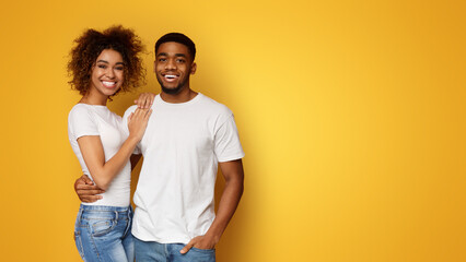 Wall Mural - Happy african american couple embracing and smiling