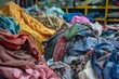 Large pile of textile fabric clothes, recycling and sustainability concept, environmental photo
