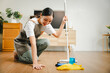 Young housewife is cleaning, wiping and mopping the floor. Clean mopping concept.
