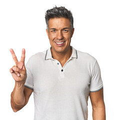 Middle-aged Latino man showing victory sign and smiling broadly.