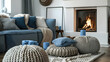 Grey sofa with blue pillows next to the fireplace and beige knit pouffes in between. a warm and inviting winter setting. Scandinavian interior design for a contemporary living room