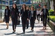 © sderbane - Morning Commute in the City. Three businesswomen walking to work in a bustling cityscape.